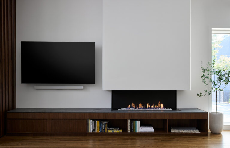 modern fireplace with tv, bookshelf, and cabinetry