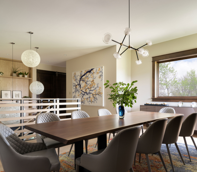 Dining room with pendant lamp wood table and white metal railing